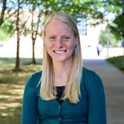 A blonde woman smiling at the camera.