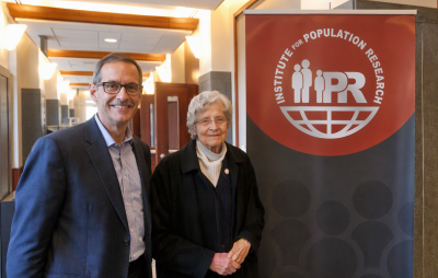 Dr. Joan Huber and Dr. Joseph Potter standing by an IPR sign