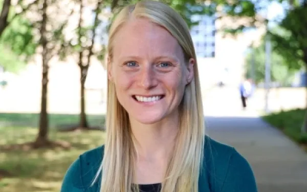 A blonde woman smiling at the camera.