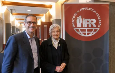 Dr. Joan Huber and Dr. Joseph Potter standing by an IPR sign