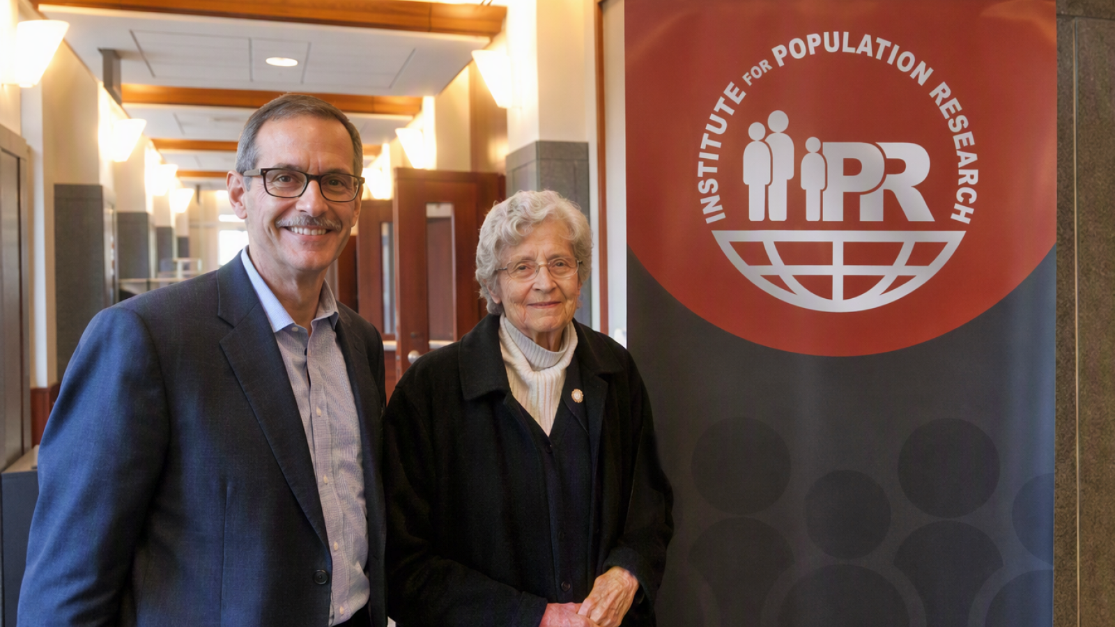 Dr. Joan Huber and Dr. Joseph Potter standing by an IPR sign